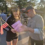 Mike Millan explains the sample ballot to a first-time voter in the Hampton District.