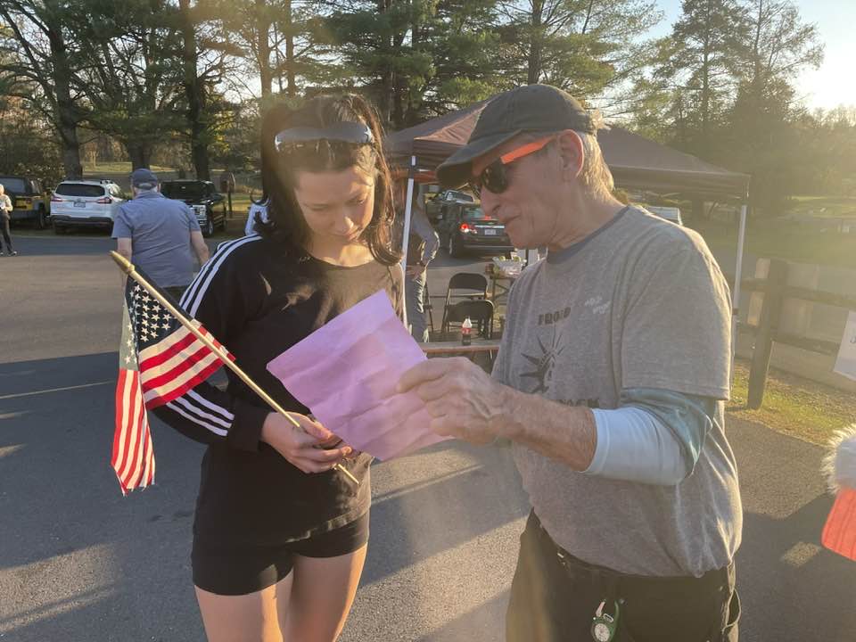 Mike Millan explains the sample ballot to a first-time voter in the Hampton District.